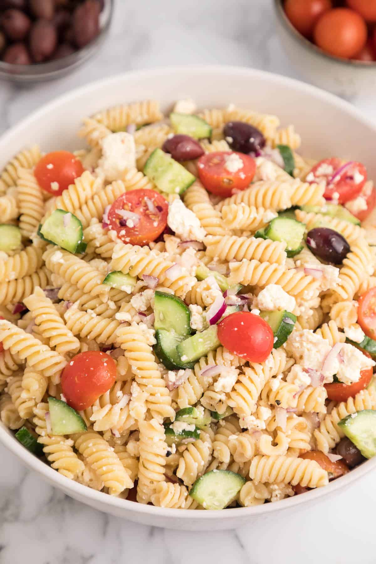 Close up of a bowl of Greek pasta salad.