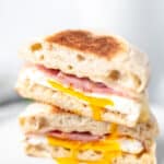 Two halves of a ham, egg and cheese breakfast sandwich with text overlay.