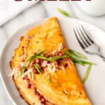 Close up of a ham and cheese omelet with text overlay.