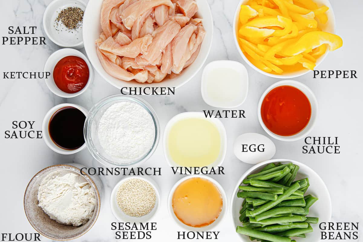 Ingredients needed to make Panda Express honey garlic chicken on a marble background with text overlay.
