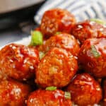 Close up of Korean BBQ Meatballs on rice with text overlay.