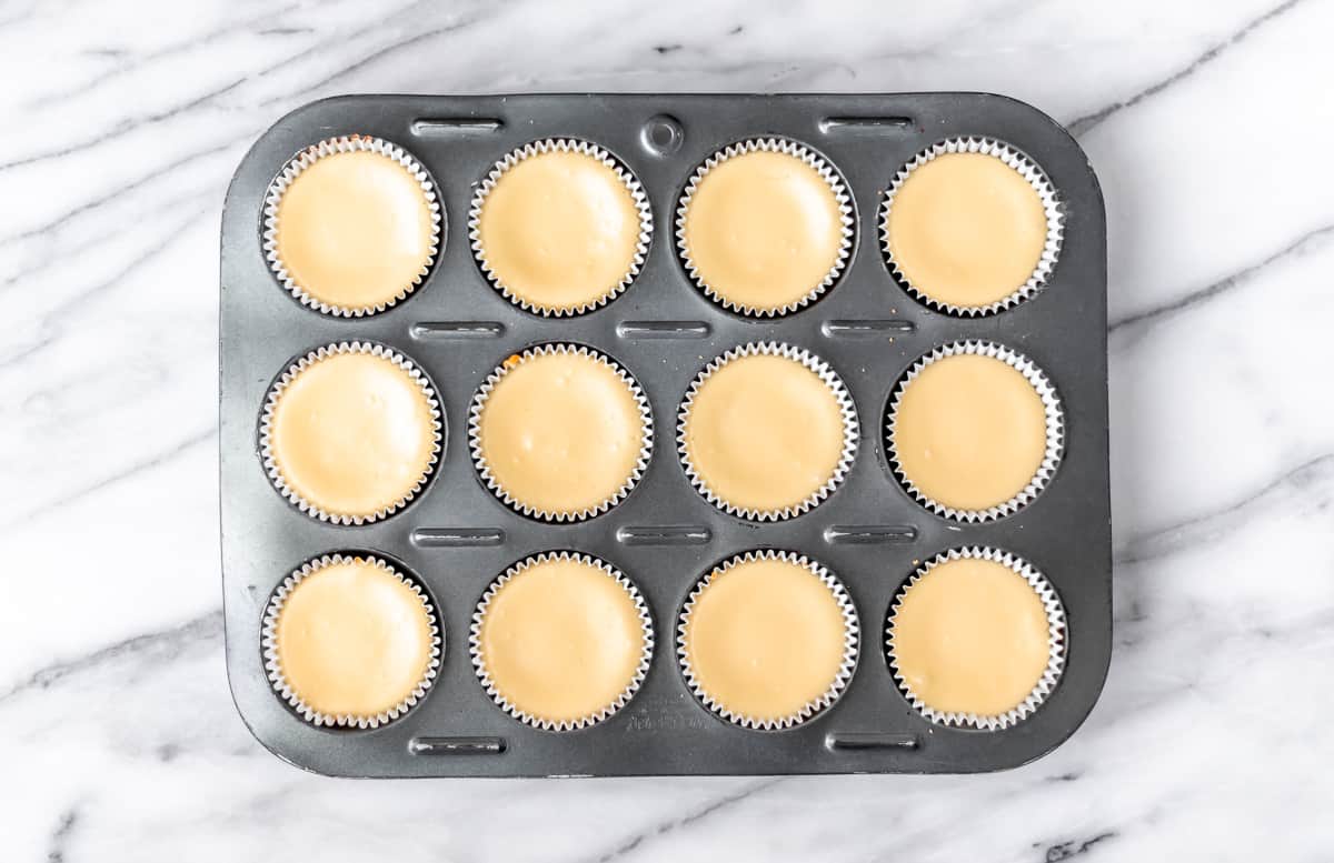 Baked mini cheesecakes in a cupcake pan.