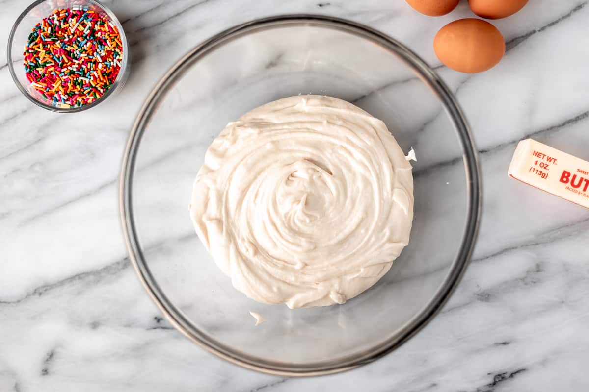 Cake batter in a large glass bowl.