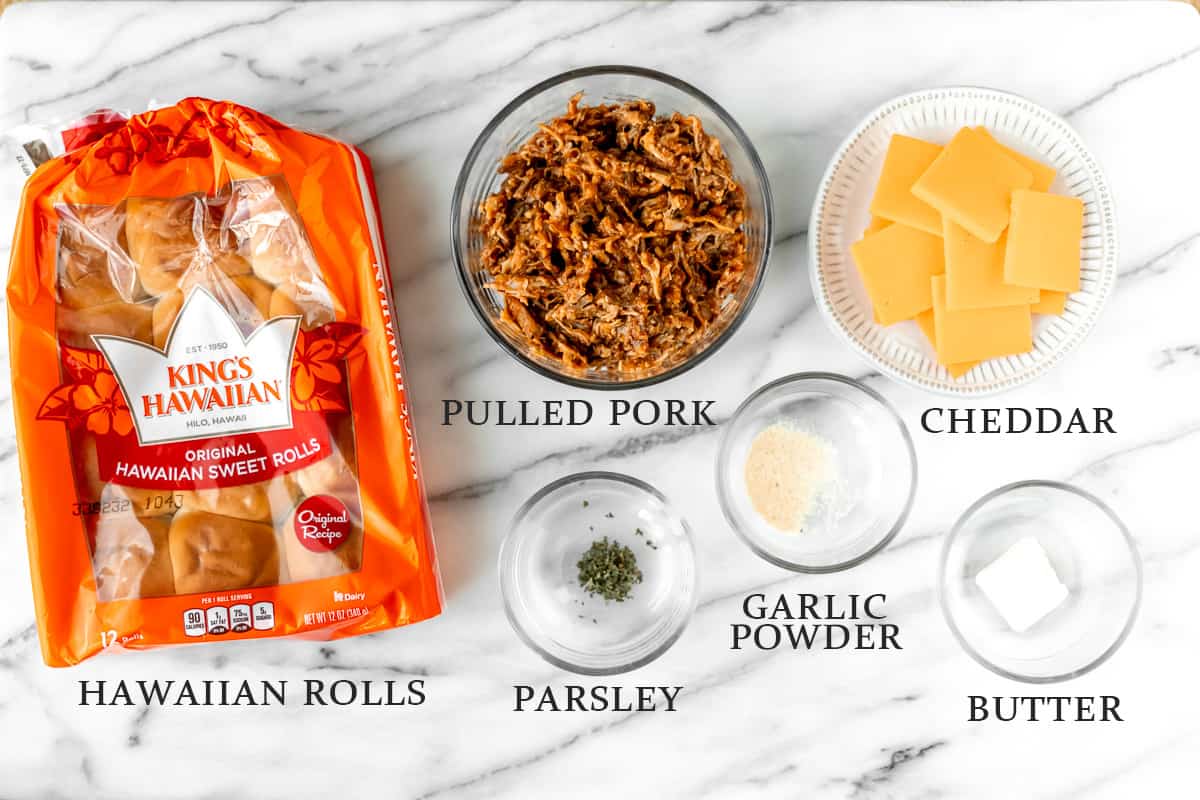 Ingredients needed for pulled pork sliders on a marble background with text overlay.