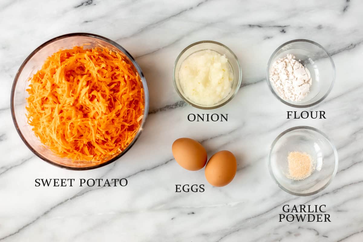 Ingredients needed to make sweet potato hash browns on a marble background with text overlay.