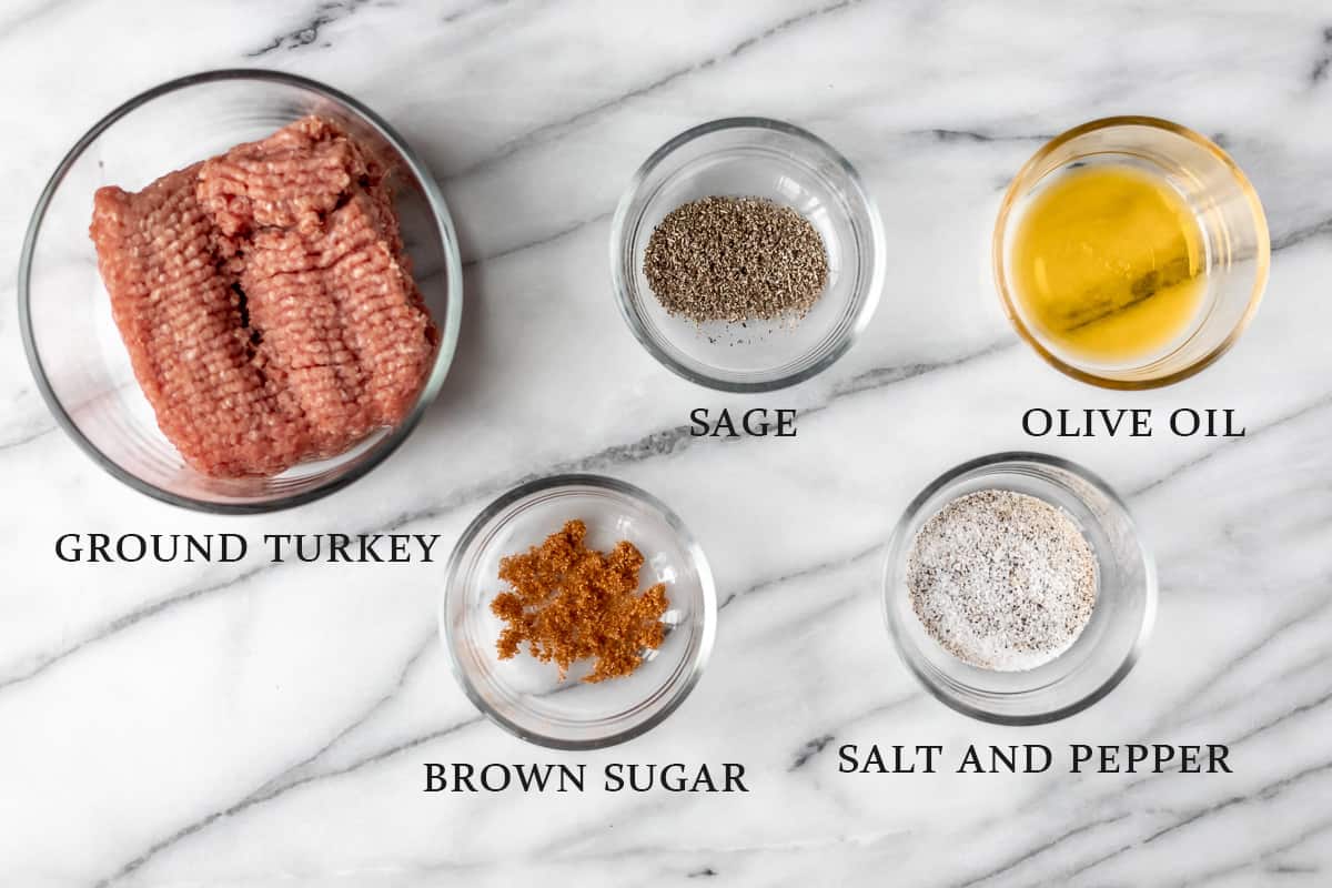 Ingredients needed to make homemade turkey sausage patties on a marble background with text overlay.