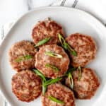 Turkey sausage patties garnished with sliced scallions with text overlay.