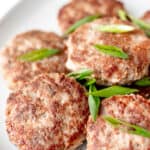 Turkey sausage patties garnished with sliced scallions with text overlay.