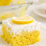 Lemon poke cake on a plate with text overlay.