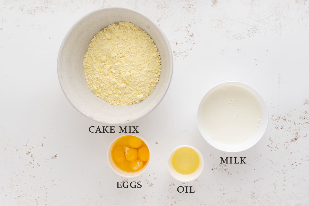 Ingredients to make a lemon cake on a white background with text overlay.