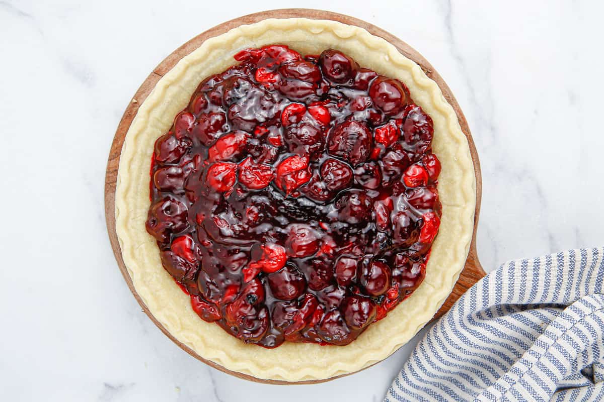 A pie crust filled with cherry filling.
