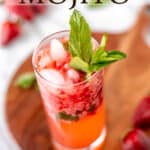 A strawberry mojito on a wood server with strawberries and mint around it with text overlay.