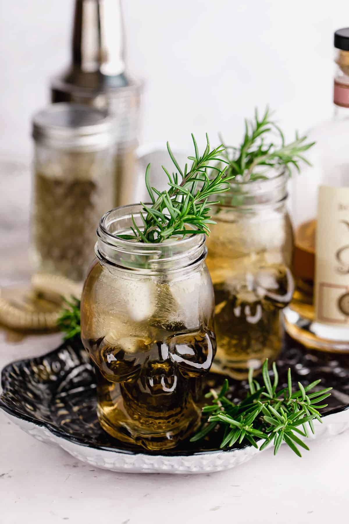 Two grave digger cocktails with fresh rosemary garnish.