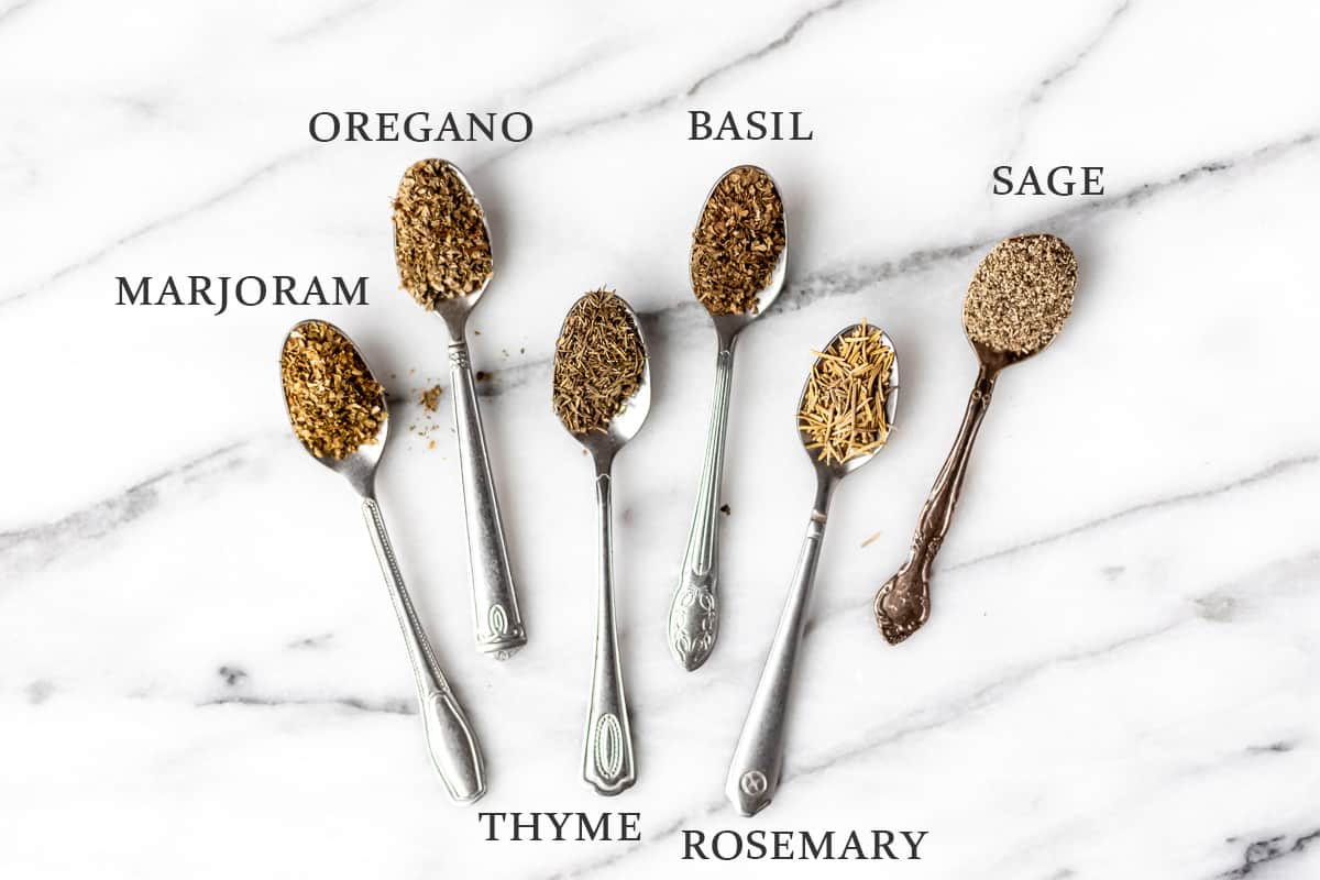 Ingredients needed to. make Italian seasoning on small spoons with text overlay.
