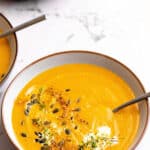 Instant pot carrot soup in a bowl with a spoon with text overlay.