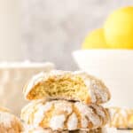 Lemon crinkle cookies with lemons in the background and text overlay.