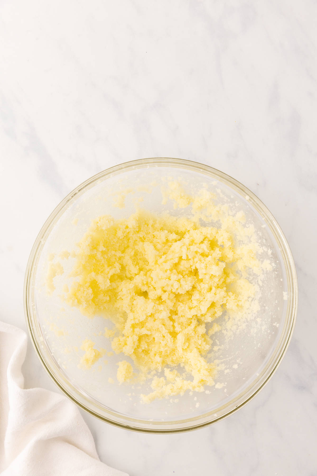 Butter and sugar beat together in a glass bowl.