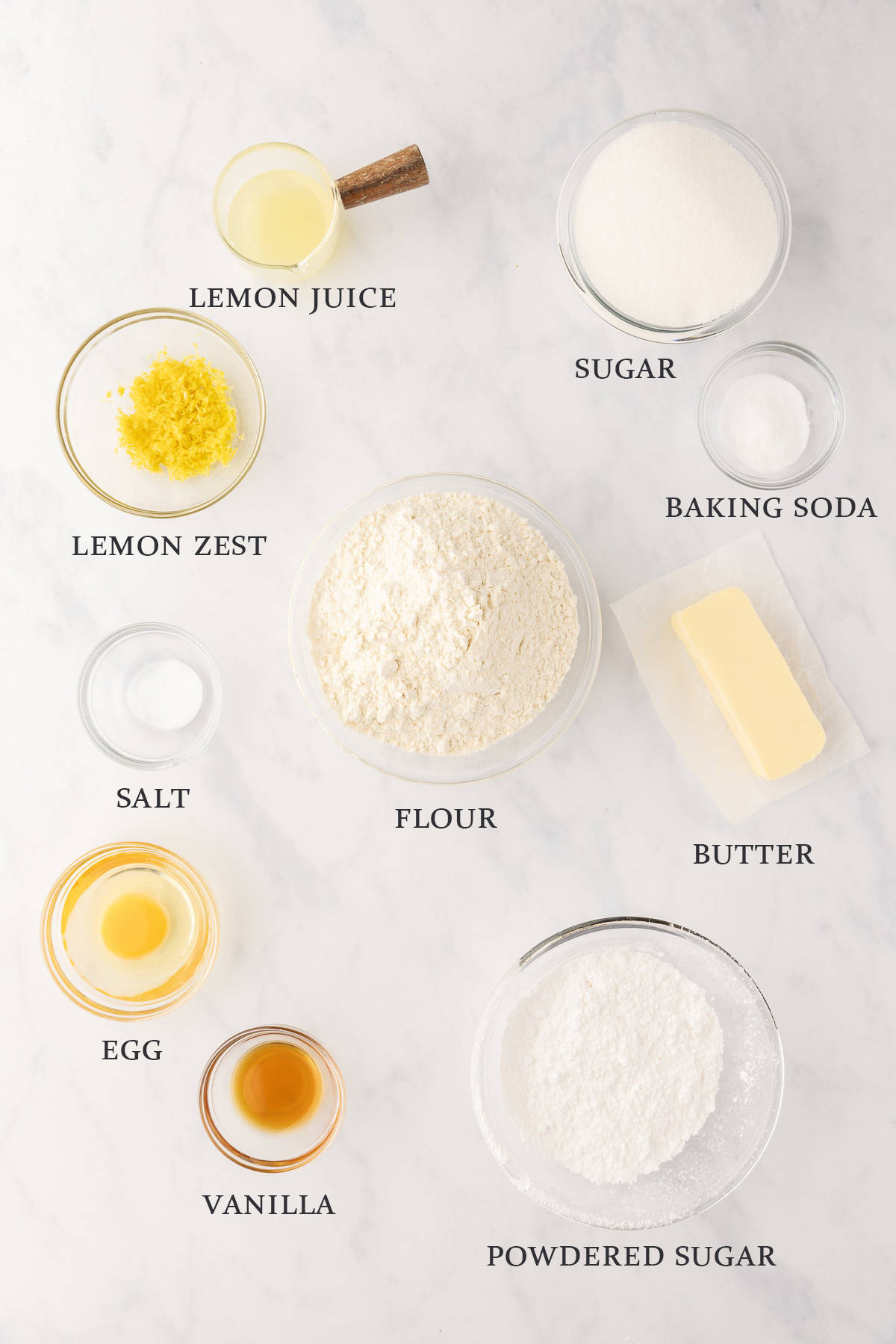 Ingredients needed to make lemon crinkle cookies on a white background with text overlay.