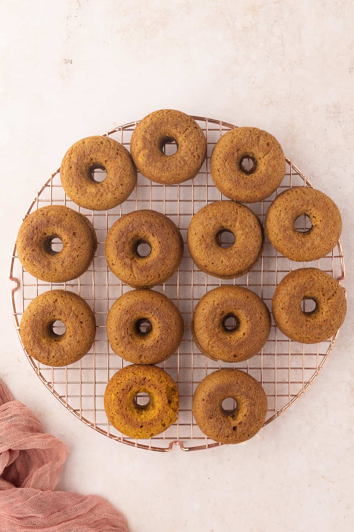 Baked donuts on a cooling rack.