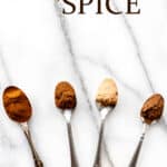 Small spoons of spices to make pumpkin pie spice on a marble background with text overlay.
