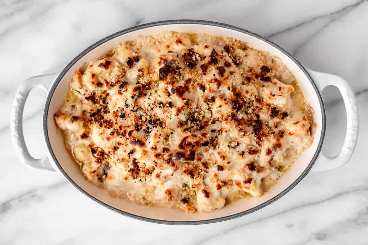 Baked truffle cauliflower mac and cheese in an oval baking dish.