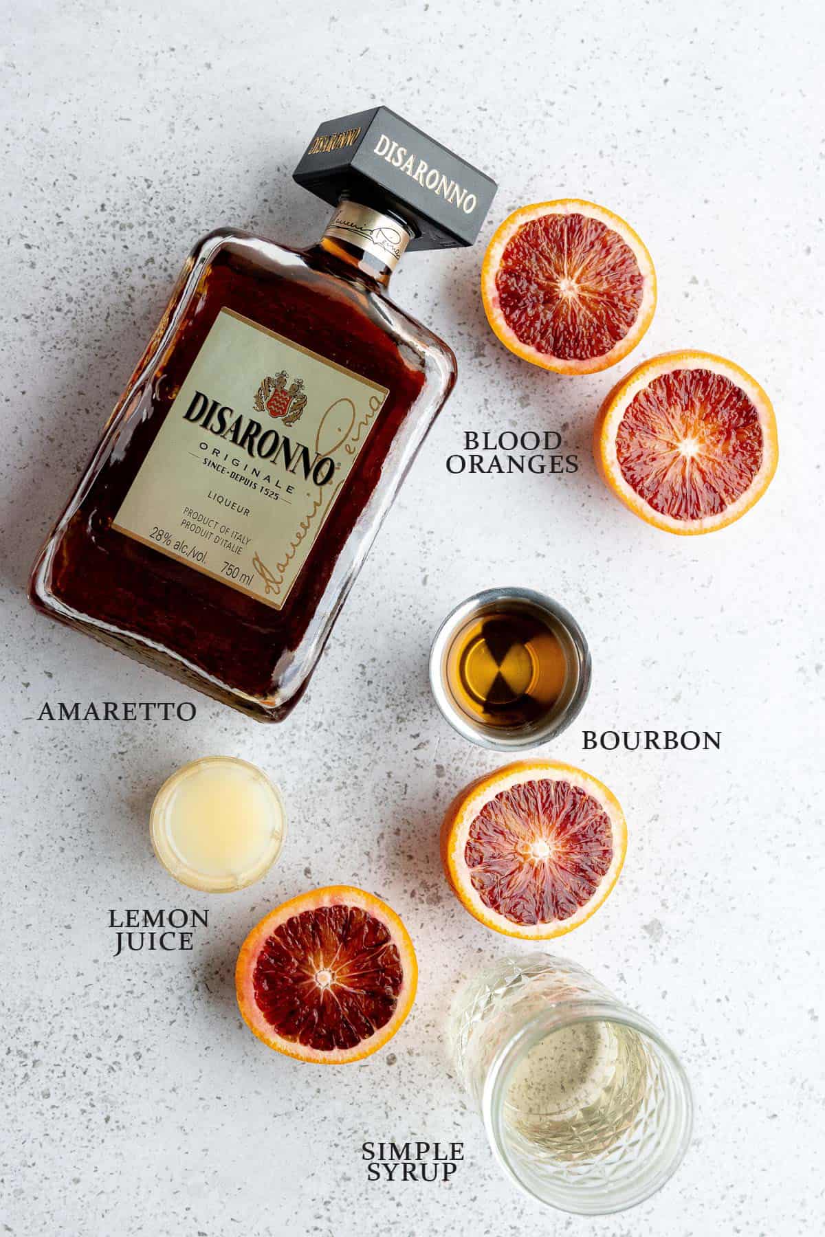 Ingredients to make a blood orange amaretto sour on a white background with text overlay.