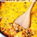 Close up of a cheesy chicken taco casserole with a wood turner lifting some up and text overlay.