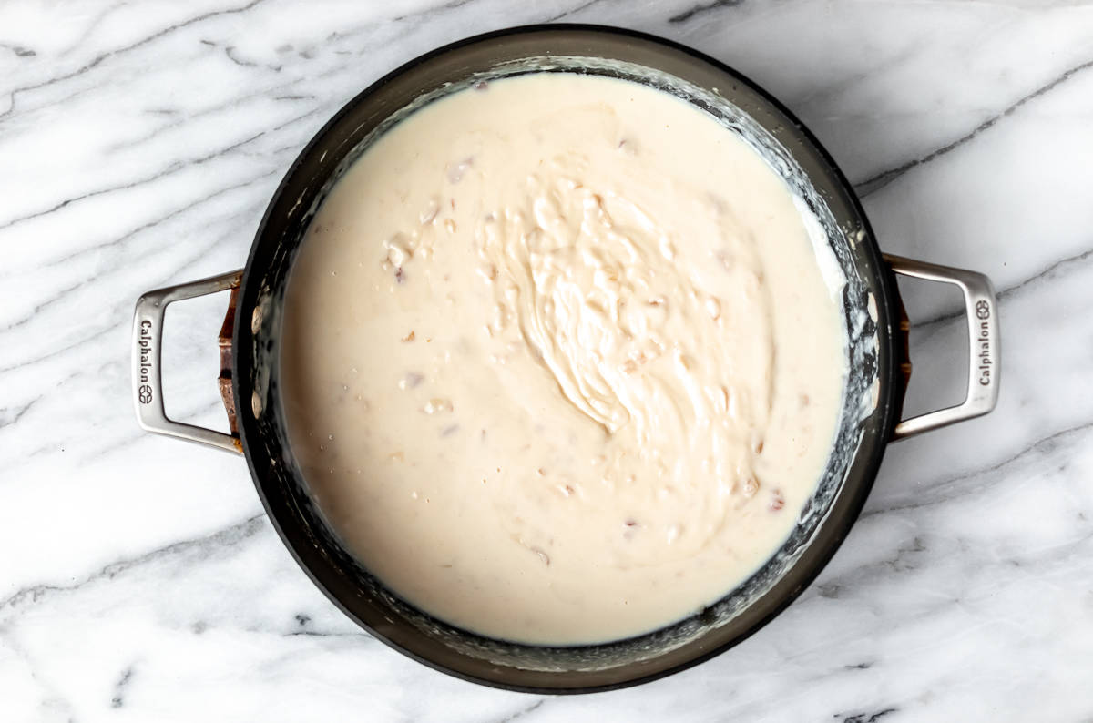 White sauce in a deep, black skillet.