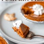 A bite of pumpkin pie on a fork on a plate with a mini pie and text overlay.