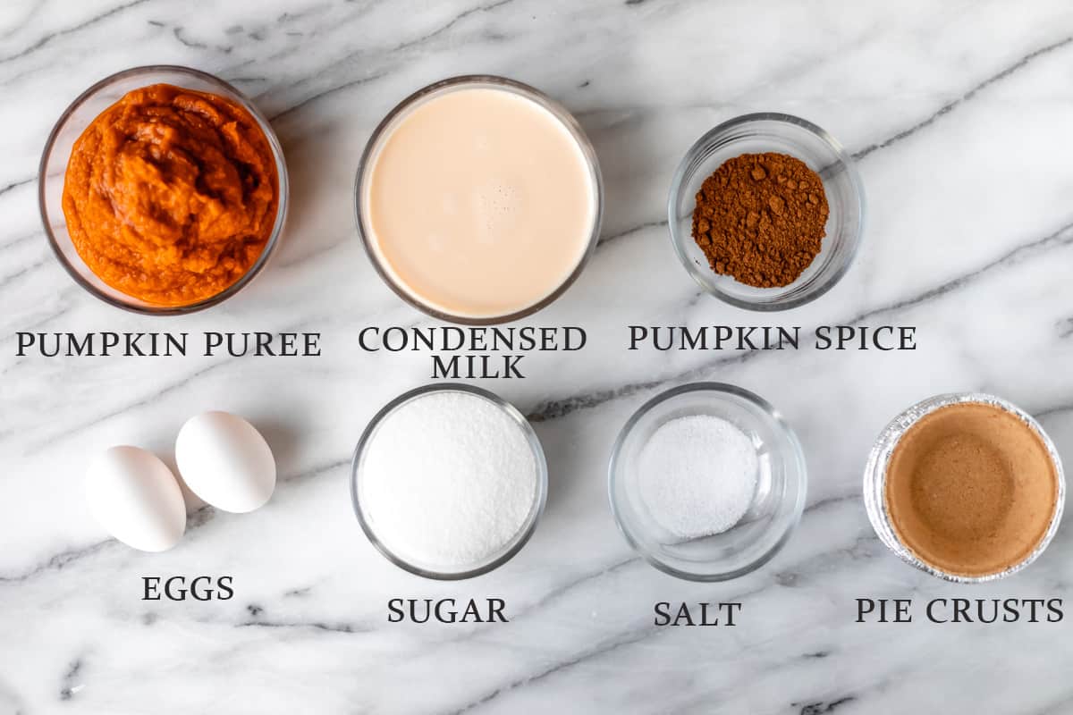 Ingredients needed to make mini pumpkin pies on a marble background with text overlay.