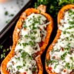 Close up of stuffed butternut squash with text overlay.