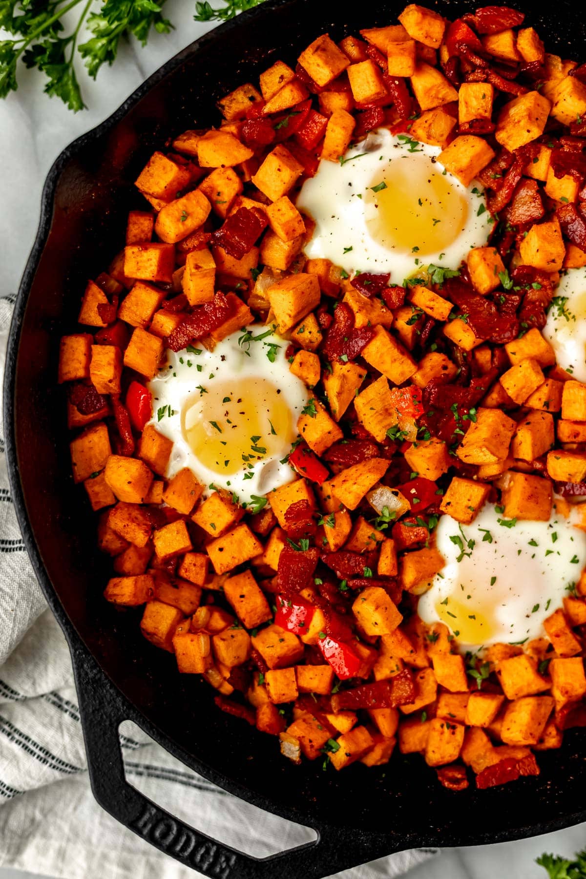 Close up of sweet potato breakfast hash in a cast iron skillet.