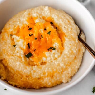 Close up of a bowl of cheddar cheese grits.