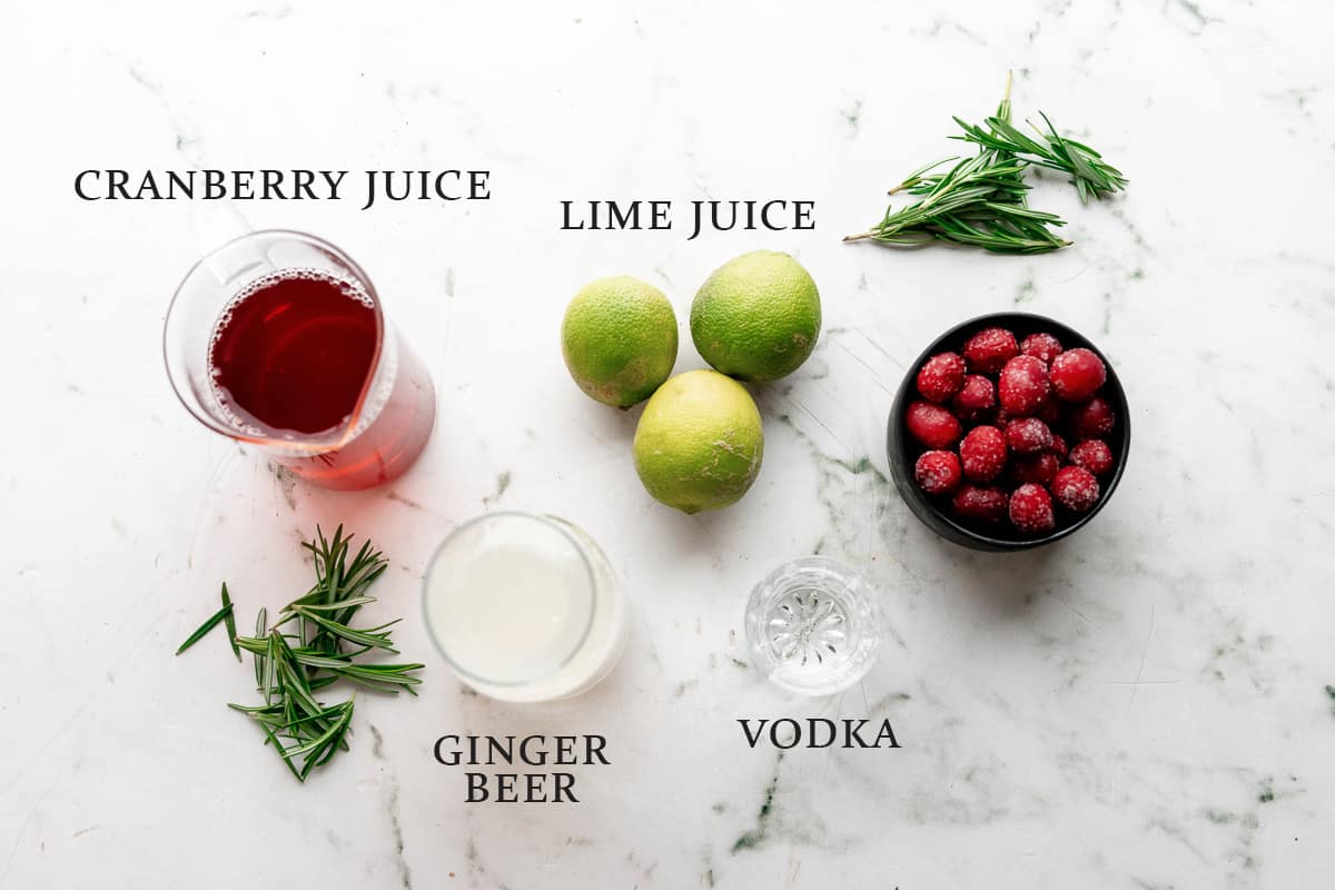 Ingredients needed to make a cranberry moscow mule with text overlay.