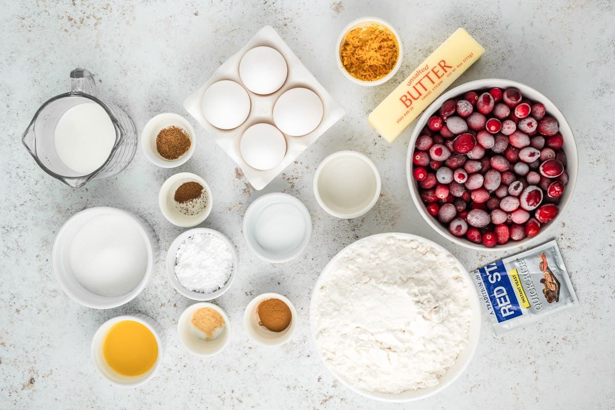 Ingredients needed to make cranberry star bread in white bowls on a white background.