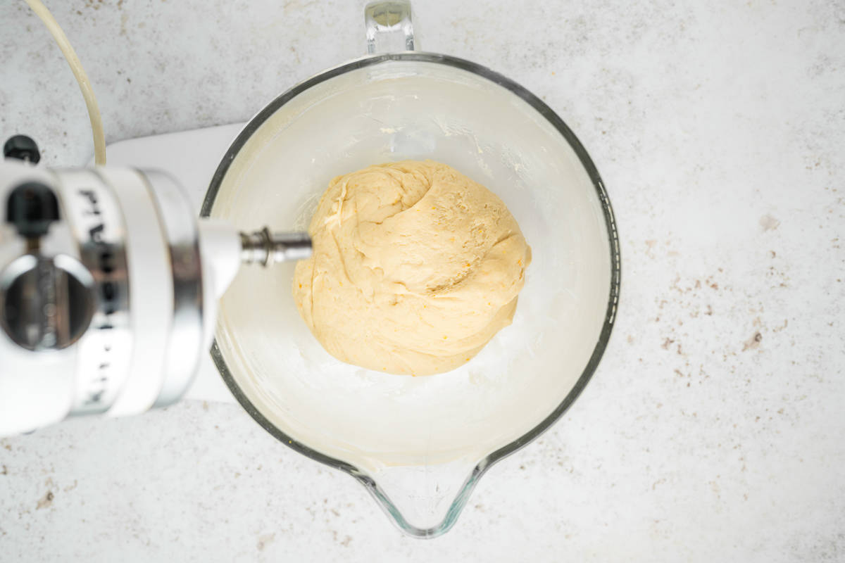 A ball of dough in a glass mixing bowl.