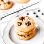 A stack of three dark chocolate chip cookies and a cooling rack with more cookies with text overlay.