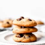 A stack of three dark chocolate chip cookies with text overlay.