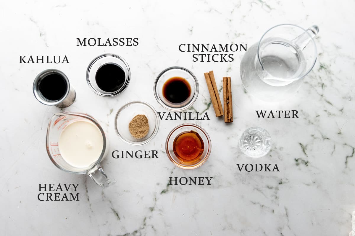 Ingredients needed to make a Gingerbread White Russian cocktail on a white background with text overlay.