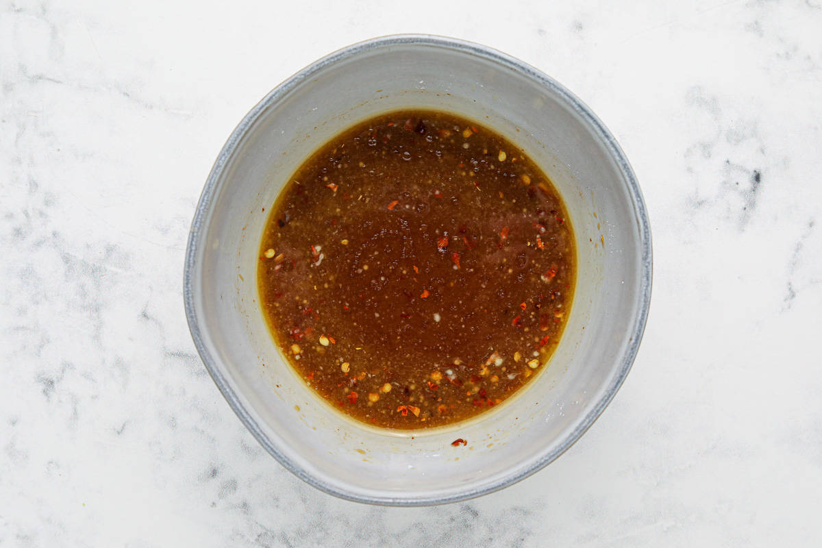 Kung Pao sauce in a bowl on a white background.