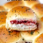 A turkey slider sitting on top of more turkey sliders with text overlay.
