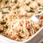 Close up of ham tetrazzini being lifted up with a fork with text overlay.