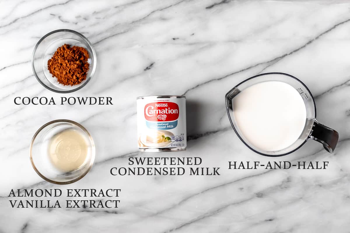 Ingredients needed to make Irish cream coffee creamer on a marble background with text overlay.