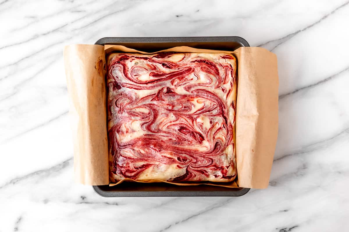 Baked red velvet cheesecake brownies in an 8-inch square baking pan.