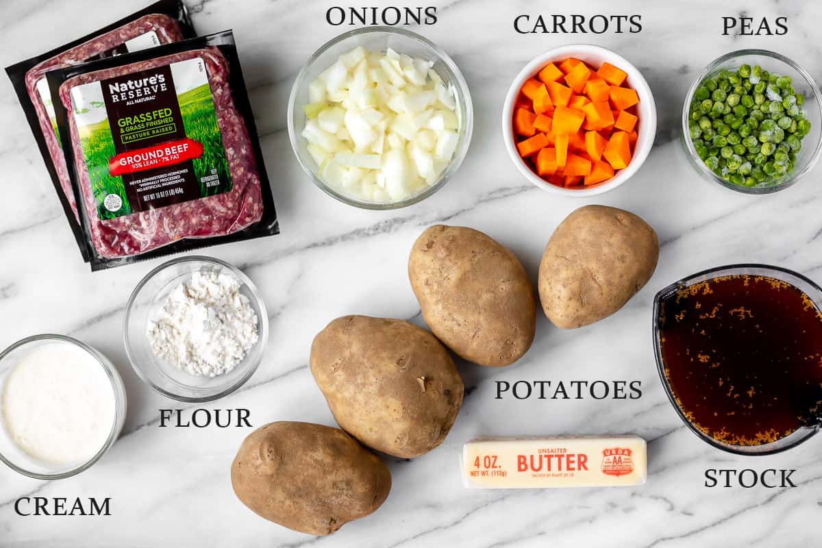 Ingredients needed to make Irish Shepherd's Pie on a marble background with text overlay.