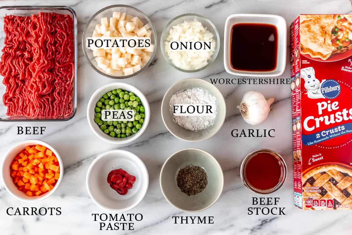 Ingredients needed to make beef hand pies on a marble surface with text overlay.