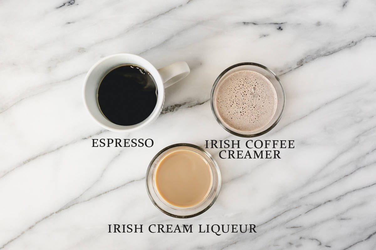 Ingredients needed to. make an Irish latte on a marble background with text overlay.