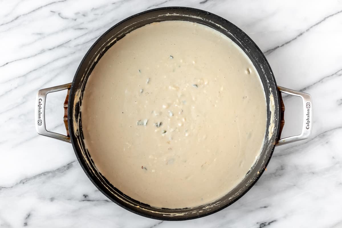 Spicy cheese sauce in a black skillet.