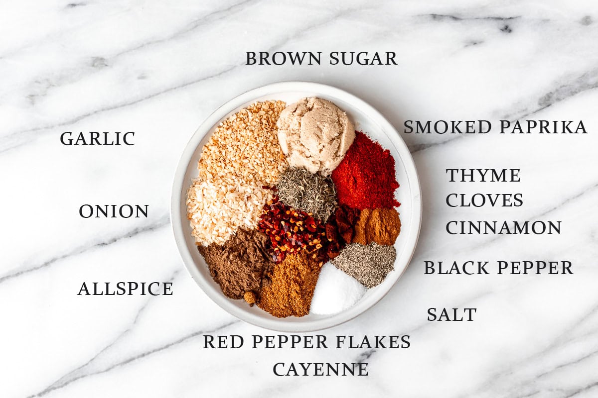 Ingredients needed to make jerk seasoning on a plate with text overlay around it.