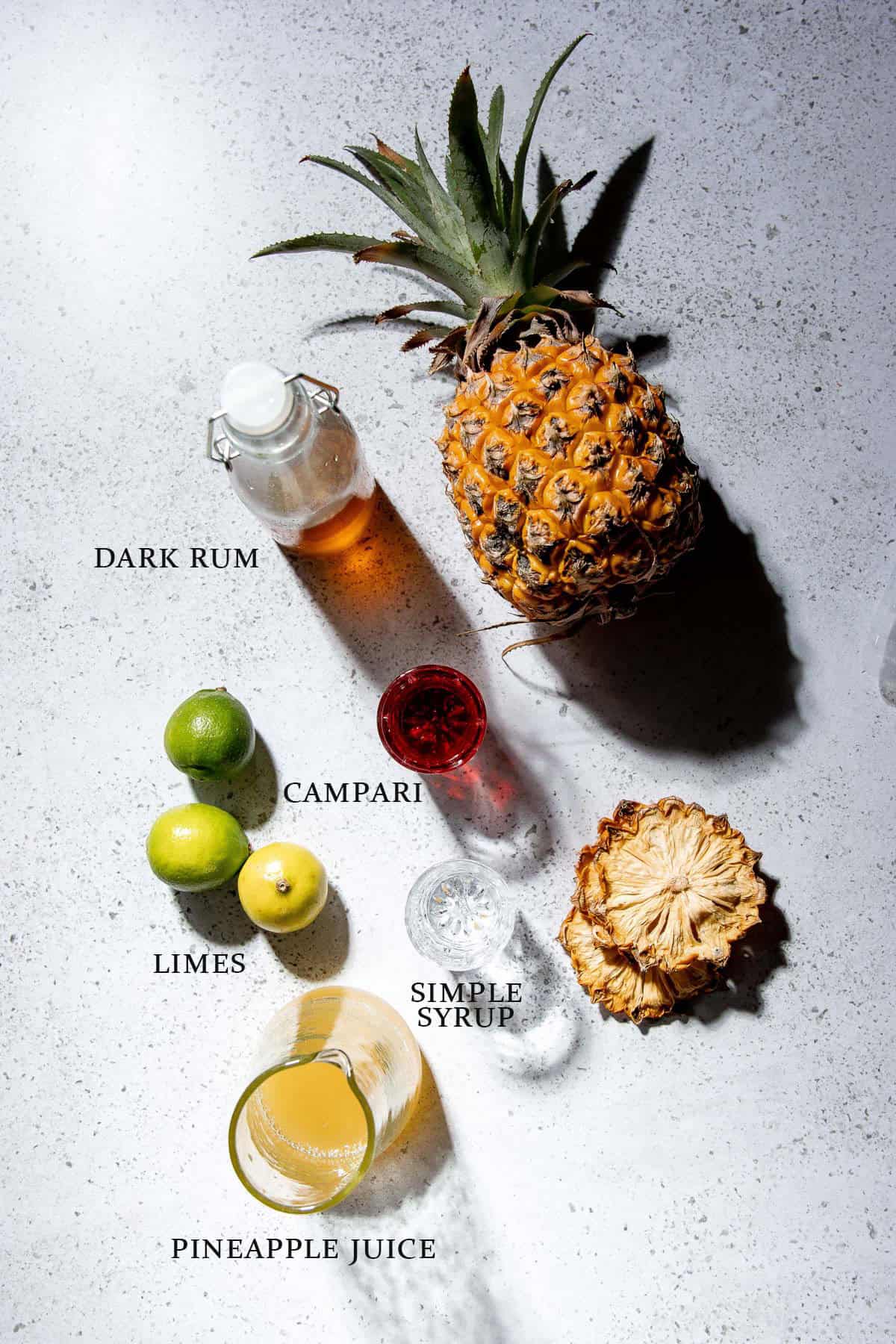Ingredients needed to make a jungle bird cocktail with text overlay.